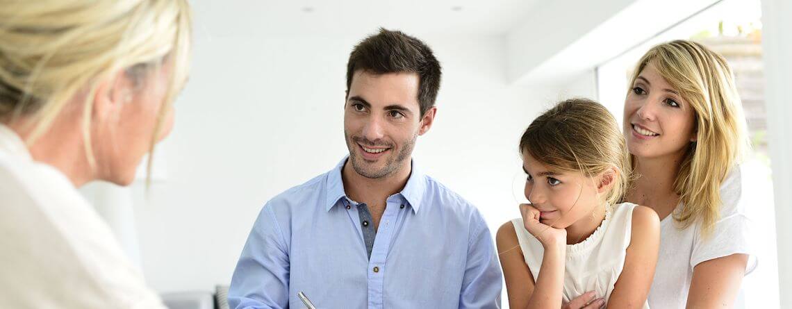 Family getting an insurance quote from their agent